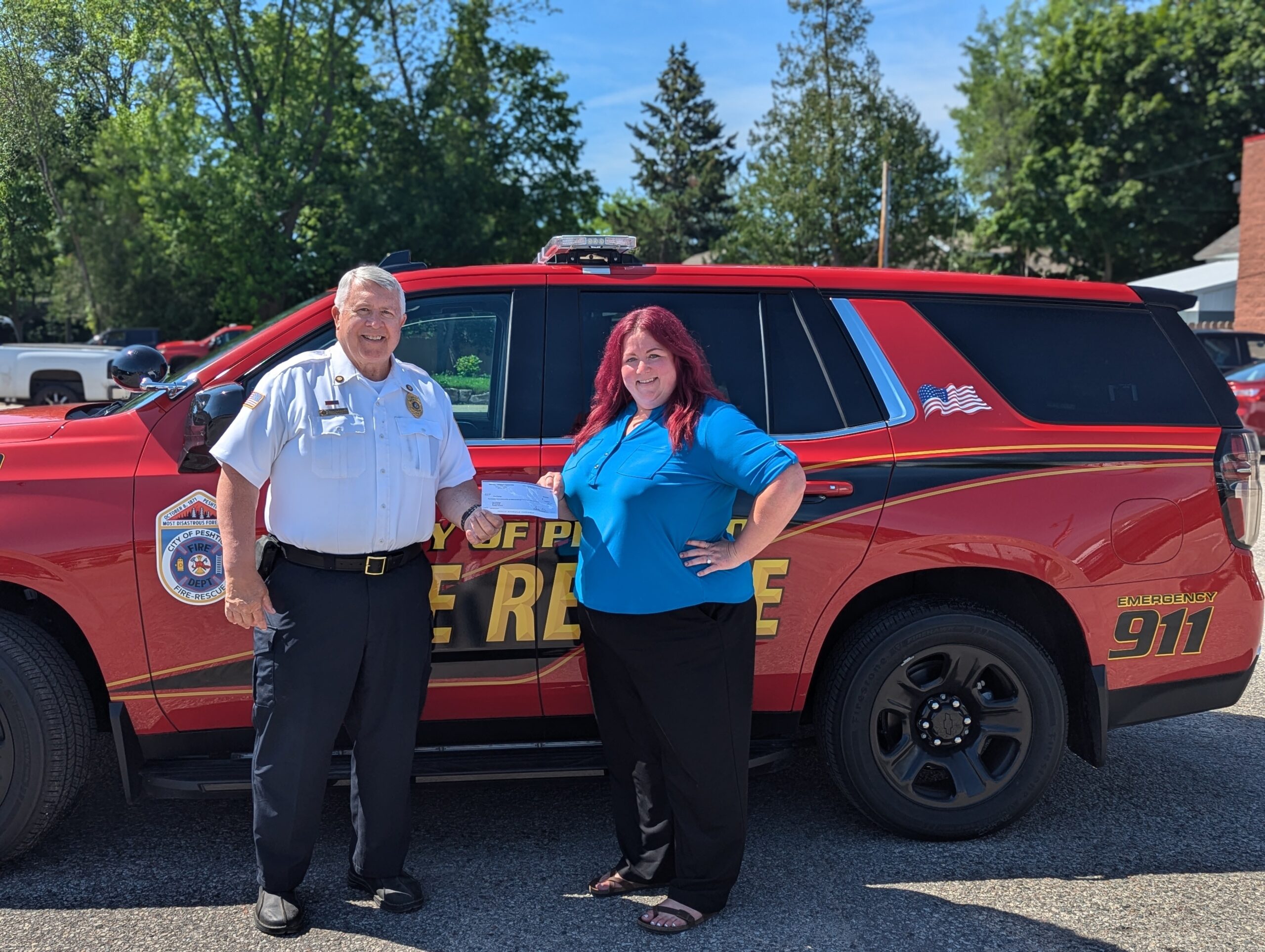 M&M Area Community Foundation Executive Director Ashley Berken presenting grantee check to City of Peshtigo Fire Department